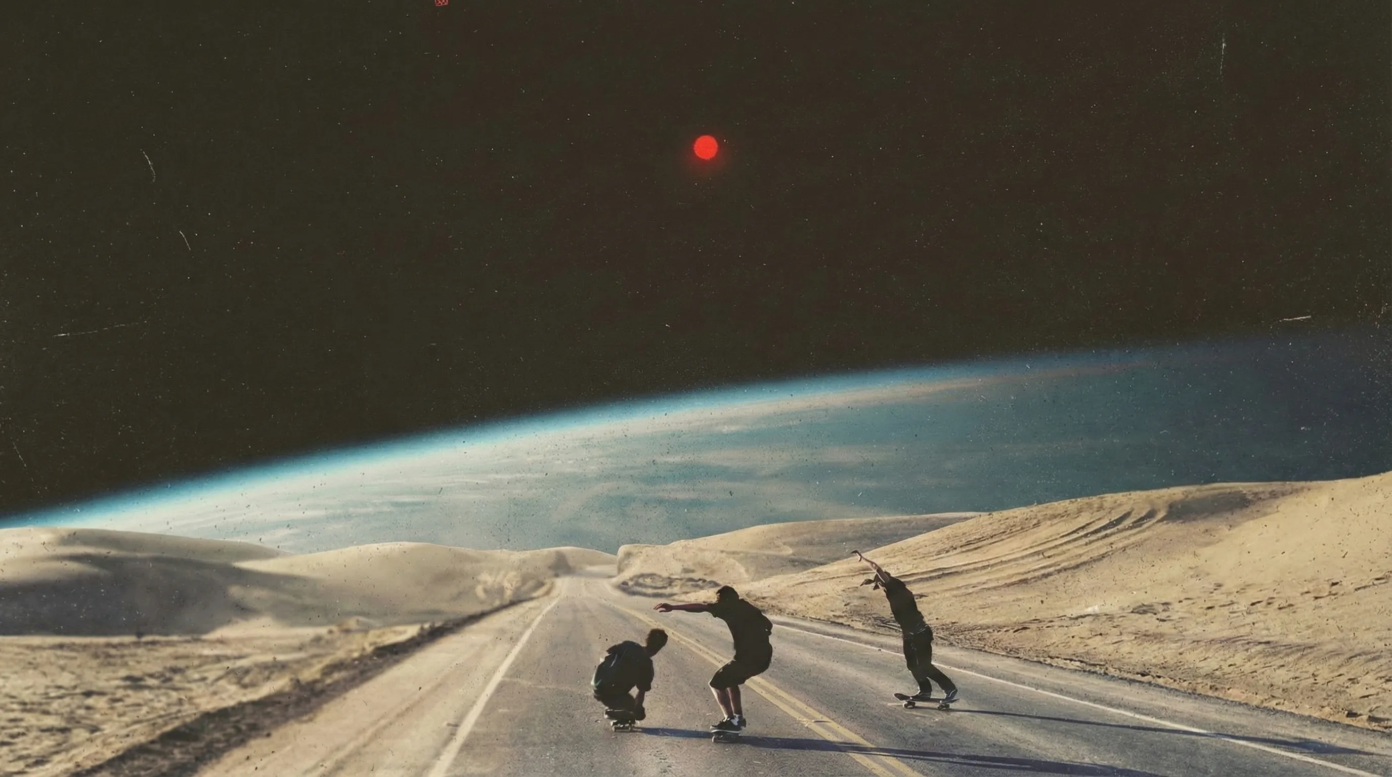 Three skateboarders on a desert road beneath the curve of a planet